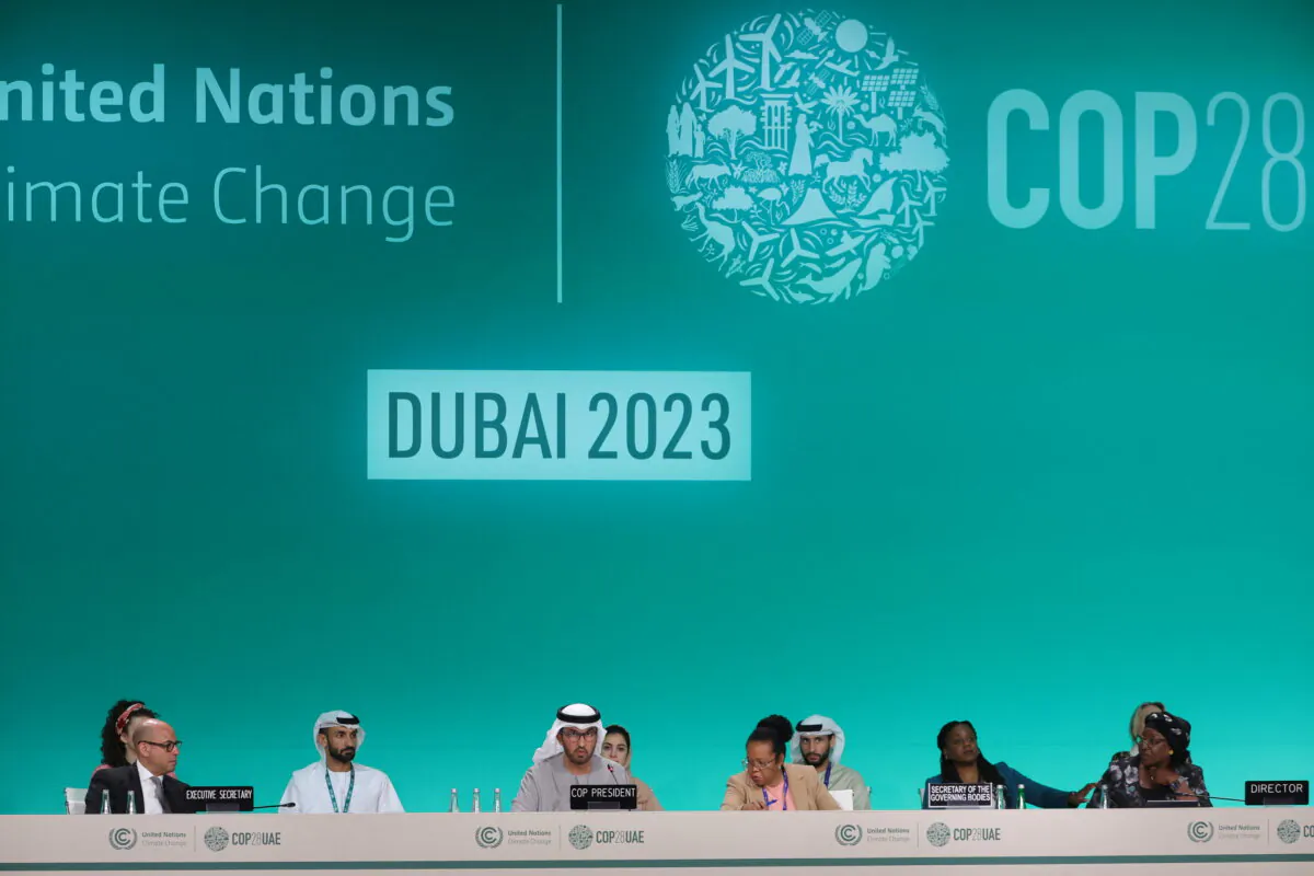 COP28 president Sultan Ahmed Al Jaber (C) and United Nations Framework Convention on Climate Change (UNFCCC) Executive Secretary Simon Stiell (L) and other officials attend a plenary session during the United Nations climate summit in Dubai on Dec. 13, 2023. (Giuseppe Cacace/AFP via Getty Images)