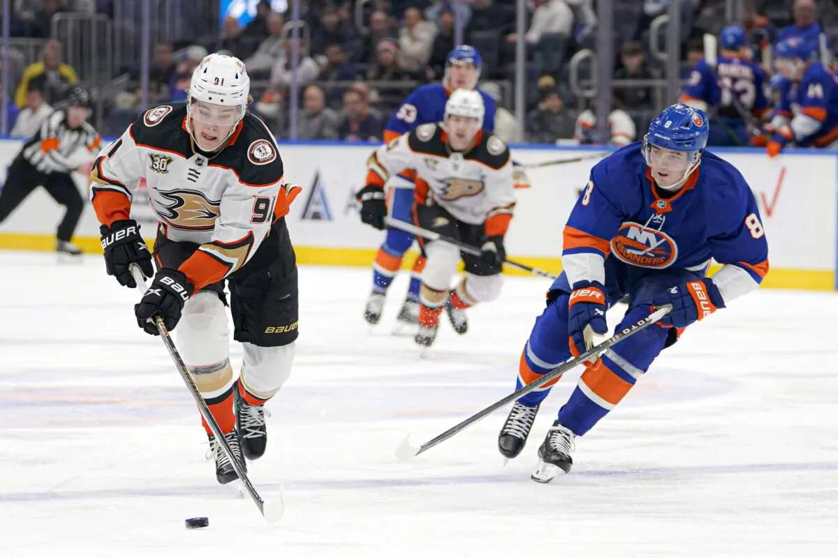 Anaheim Ducks center Leo Carlsson (91) is pursued by New York Islanders defenseman Noah Dobson (8) during the second period of an NHL hockey game in Elmont, N.Y., on Dec. 13, 2023. (Peter K. Afriyie/AP Photo)