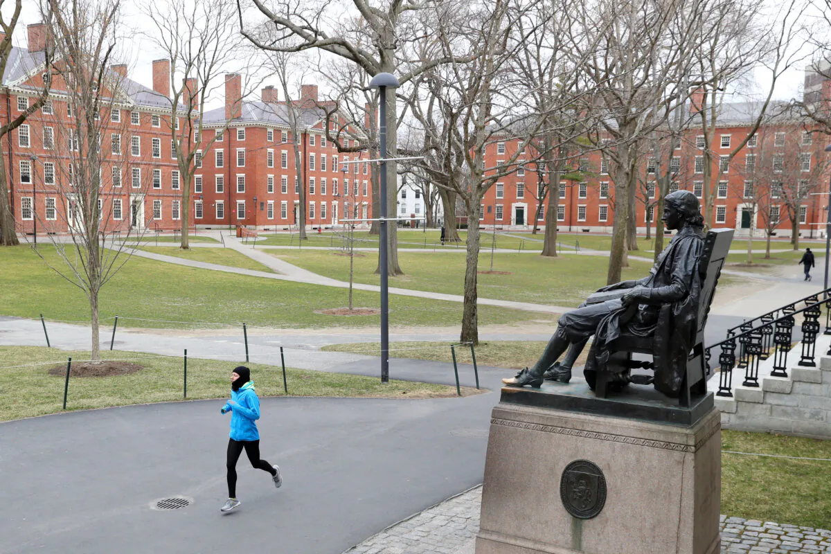 A runner crosses Harvard Yard in Cambridge, Mass., on March 23, 2020. (Maddie Meyer/Getty Images)