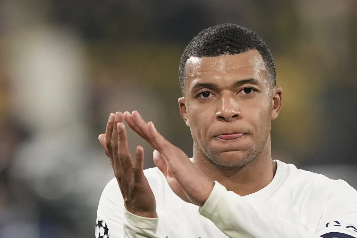 PSG's Kylian Mbappe applauds after the Champions League Group F soccer match between Borussia Dortmund and Paris Saint-Germain at the Signal Iduna Park in Dortmund, Germany, on Dec. 13, 2023. (Martin Meissner/AP Photo)