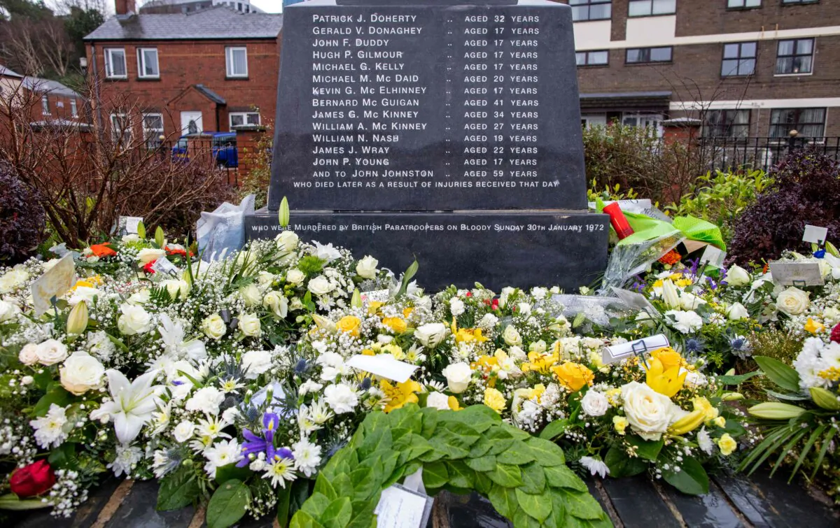 Flowers laid at the Bloody Sunday memorial, a monument to those killed on Bloody Sunday, in Londonderry (Derry), Northern Ireland, on Jan. 30, 2022, on the 50th anniversary of the Bloody Sunday shootings. (Paul Faith/AFP via Getty Images)