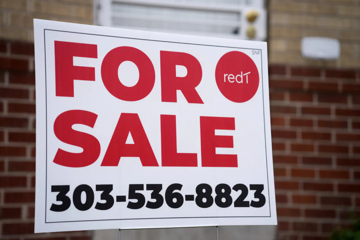 A for sale sign stands outside a single-family residence in Denver on Nov. 23, 2023. (David Zalubowski/AP Photo)