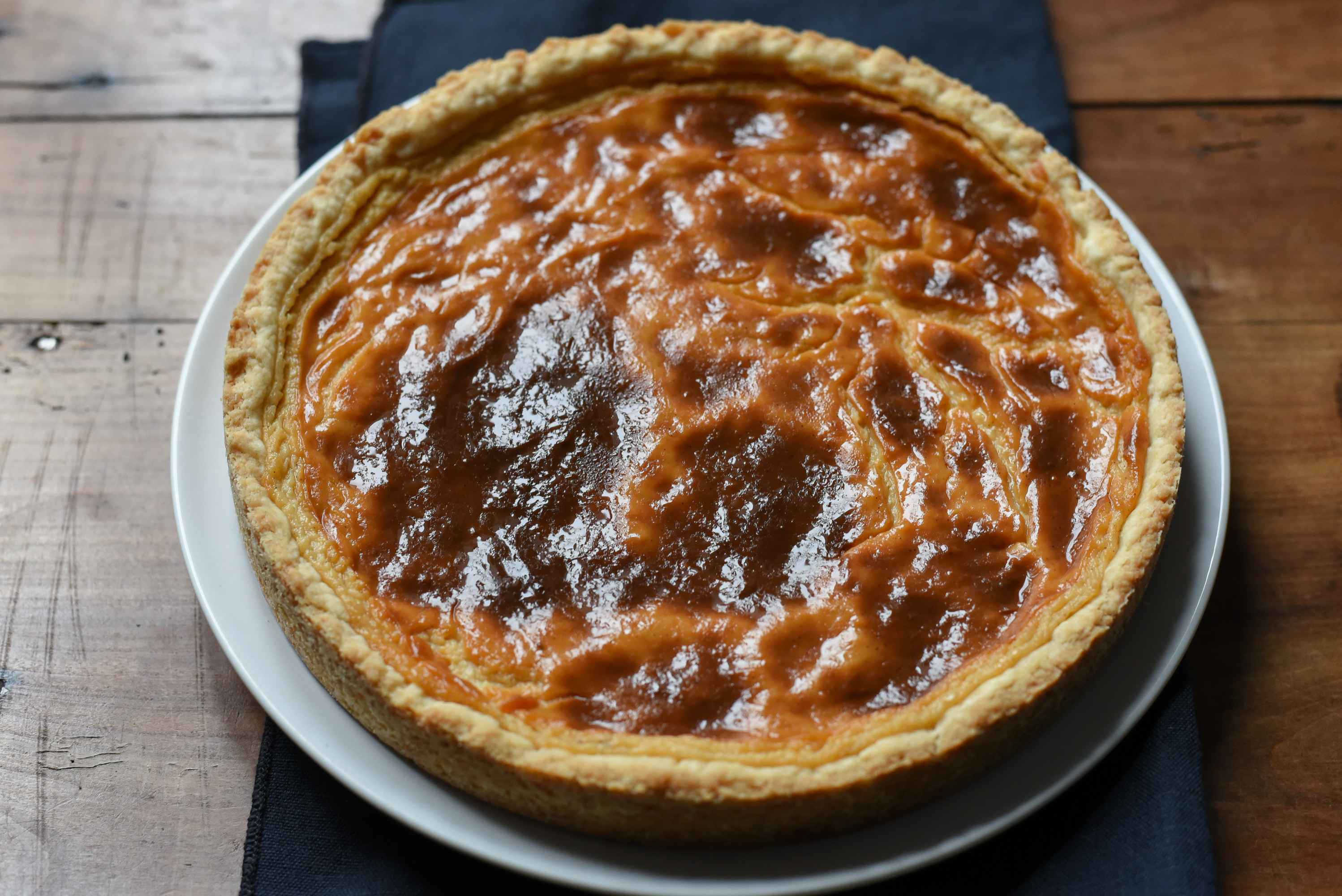 Pour the hot custard immediately into the pie shell, trim the crust, and bake until the crust is set and the custard is golden-brown. (Audrey Le Goff)