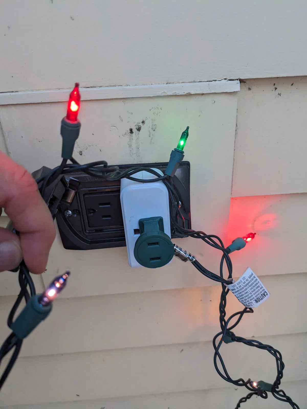 The odd white rectangle is a smart outlet. It is able to turn on and off via the WiFi in your home, allowing you to control when power flows through a cable to lights, a fountain or any other object powered by electricity. (Tim Carter/Tribune Content Agency/TNS)
