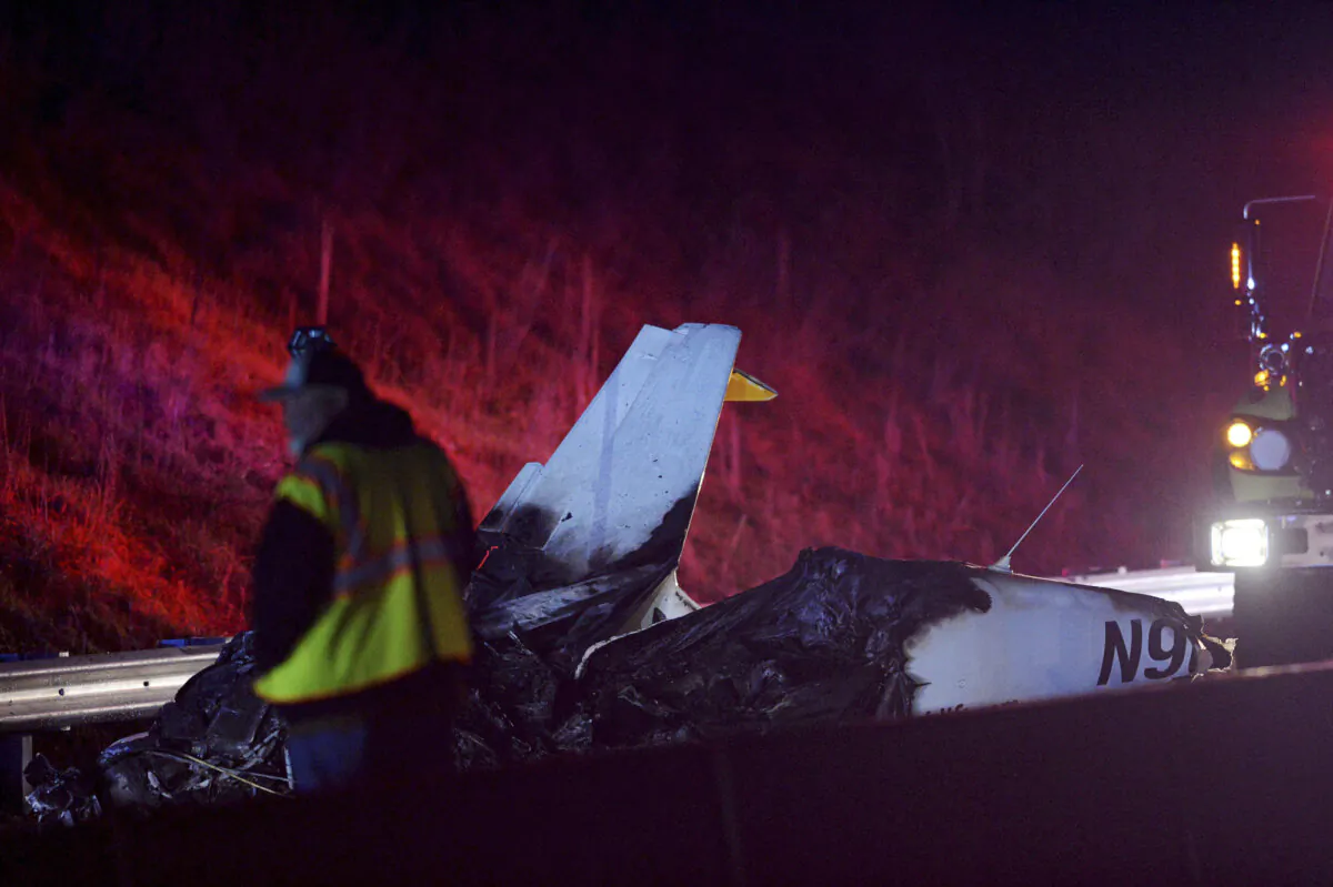 Emergency responders work the scene of a small plane that crashed on Interstate 26 West near Asheville, N.C, on Dec. 14, 2023. (Angela Wilhelm/The Asheville Citizen-Times via AP)