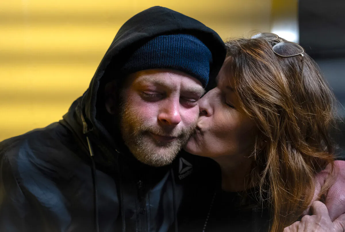 Jackie Berlin embraces her son Corey who is homeless and addicted to fentanyln San Francisco, Calif., on Feb. 22, 2023. (John Fredricks/The Epoch Times)