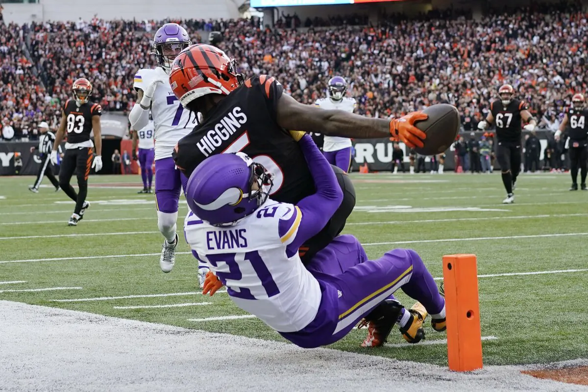 Cincinnati Bengals wide receiver Tee Higgins (5) reaches for the end zone to score a touchdown over Minnesota Vikings cornerback Akayleb Evans (21) of an NFL football game in Cincinnati on Dec. 16, 2023. (Carolyn Kaster/AP Photo/)