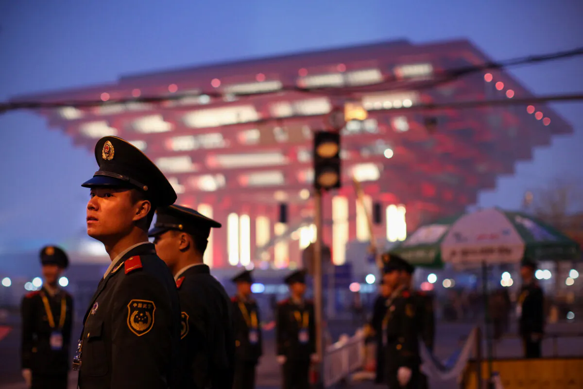 Paramilitary policemen stand guard at the entrance of the World Expo near China Pavilion in Shanghai, China, on April 19, 2010. (Feng Li/Getty Images)