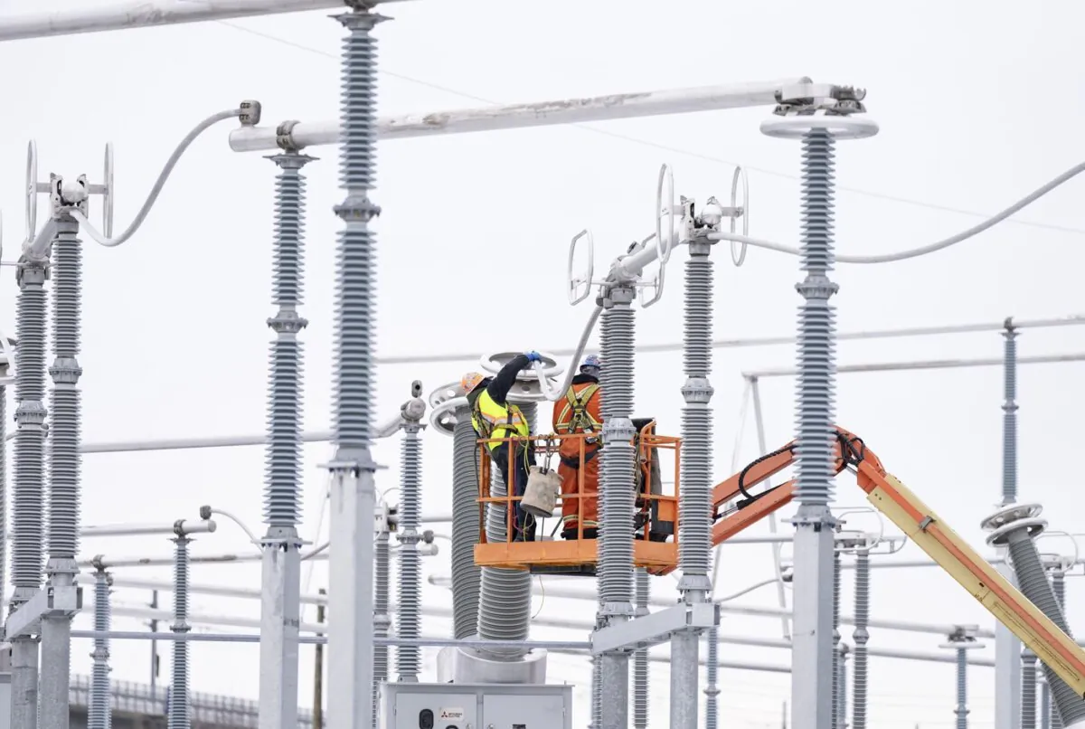 Hydro Quebec employees work on the construction site of a new substation in Montreal on Dec. 12, 2023. (The Canadian Press/Christinne Muschi)