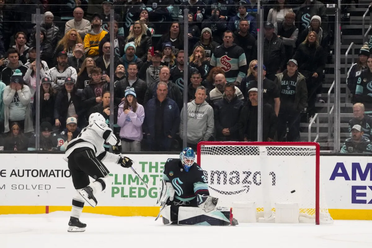 Los Angeles Kings right wing Carl Grundstrom (91) makes the game-winning goal against Seattle Kraken goaltender Joey Daccord during a shootout in an NHL hockey game in Seattle on Dec. 16, 2023. (Lindsey Wasson/AP Photo)