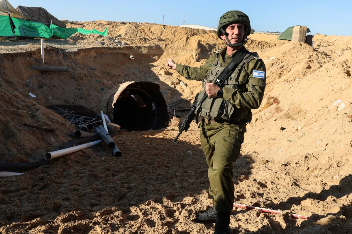 During a media tour organized by the Israeli military on Dec. 15, 2023, army spokesman Daniel Hagari shows the entrance of a tunnel that Hamas reportedly used to attack Israel through the Erez border crossing on Oct. 7, 2023. (Jack Guez/AFP via Getty Images)