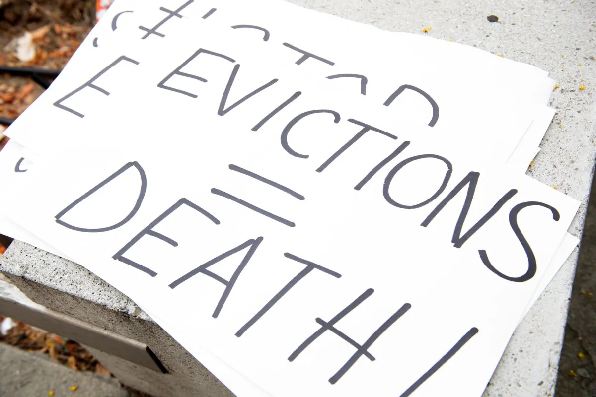 Signs are seen during a protest to cancel rent and avoid evictions in front of the court house amid coronavirus pandemic in Los Angeles on Aug. 21, 2020. (Valerie Macon/AFP via Getty Images)