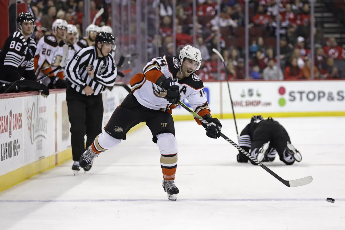 Anaheim Ducks center Adam Henrique shoots and scores an empty-net goal for a hat trick against the New Jersey Devils during the third period of an NHL hockey game in Newark, N.J., on Dec. 17, 2023. (Adam Hunger/AP Photo)