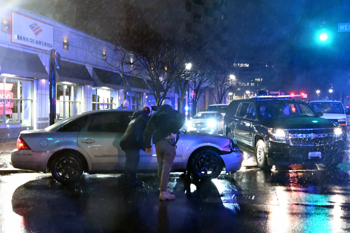 Members of the U.S. Secret Service rush to a car after it hit a motorcade SUV, as President Joe Biden was leaving his campaign headquarters in Wilmington, Del., on Dec. 17, 2023. (Andrew Caballero-Reynolds/AFP via Getty Images)