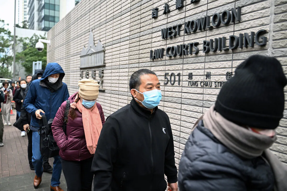 Members of the public enter the West Kowloon court for the opening day of the trial of pro-democracy media tycoon Jimmy Lai in Hong Kong on Dec. 18, 2023. (Peter Parks/AFP via Getty Images)