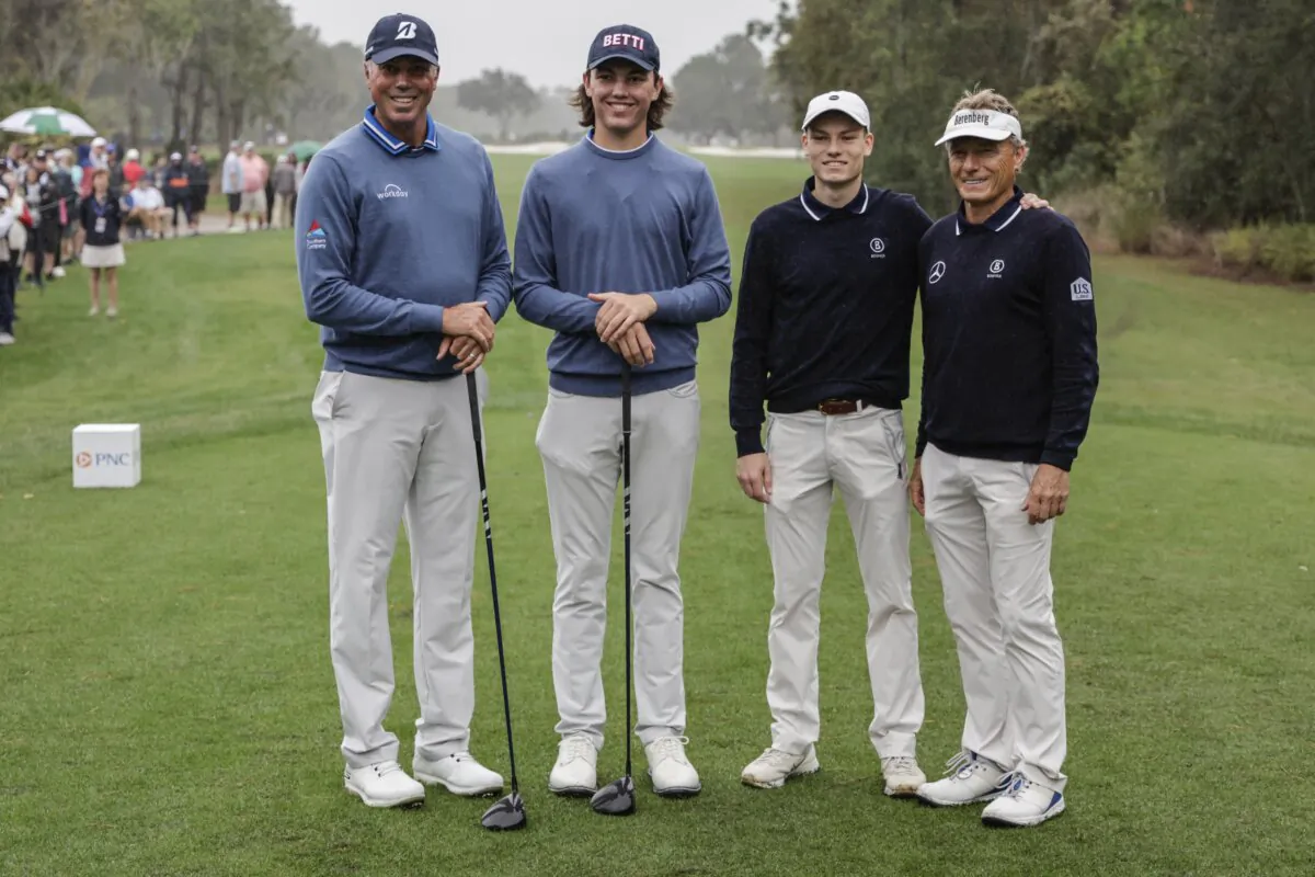 First round leaders Matt Kuchar (L) and son Cameron  (center L); Jason Lander, (center R); and father Bernard (R); stand at the first tee during the final round of the PNC Championship golf tournament in Orlando, Fla., on Dec. 17, 2023 (Kevin Kolczynski/AP Photo)