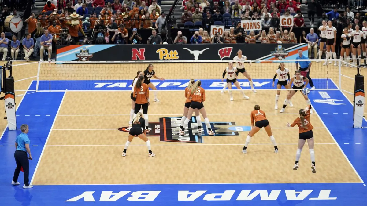 Texas, foreground, serves to Nebraska during the championship match in the NCAA Division I women's college volleyball tournament in Tampa, Fla., on Dec. 17, 2023. (Chris O'Meara/AP Photo)