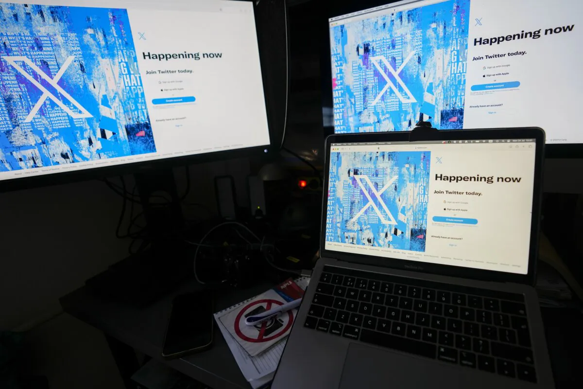 Computer monitors and a laptop display the sign-in page of X, formerly known as Twitter, in Belgrade, Serbia, on July 24, 2023. (Darko Vojinovic/AP Photo)