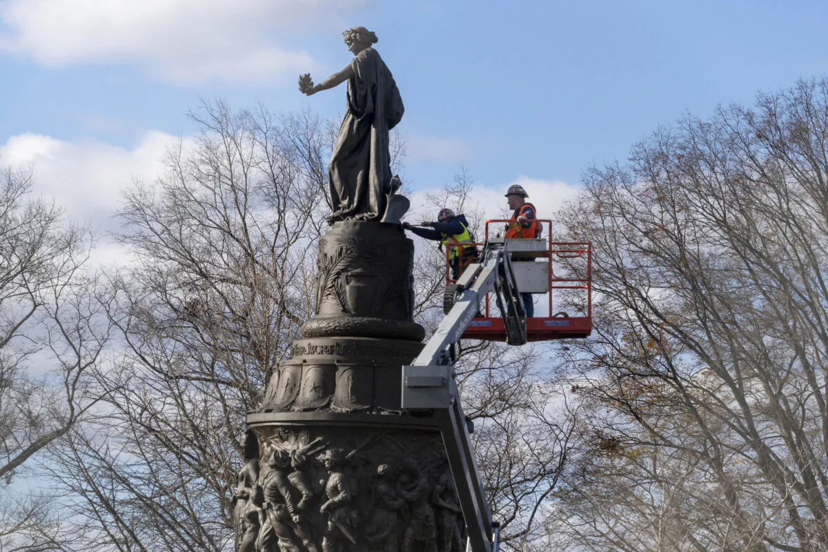 Workers prepare a Confederate Memorial for removal in Arlington National Cemetery in Arlington, Va., on Dec. 18, 2023. (Kevin Wolf/AP Photo)