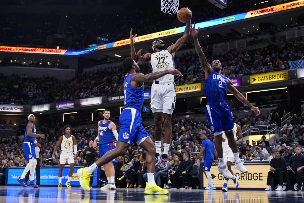 Indiana Pacers forward Isaiah Jackson (22) shoots between Los Angeles Clippers forward Paul George (13) and forward Kawhi Leonard (2) during the first half of an NBA basketball game in Indianapolis, on Dec. 18, 2023. (Michael Conroy/AP Photo)