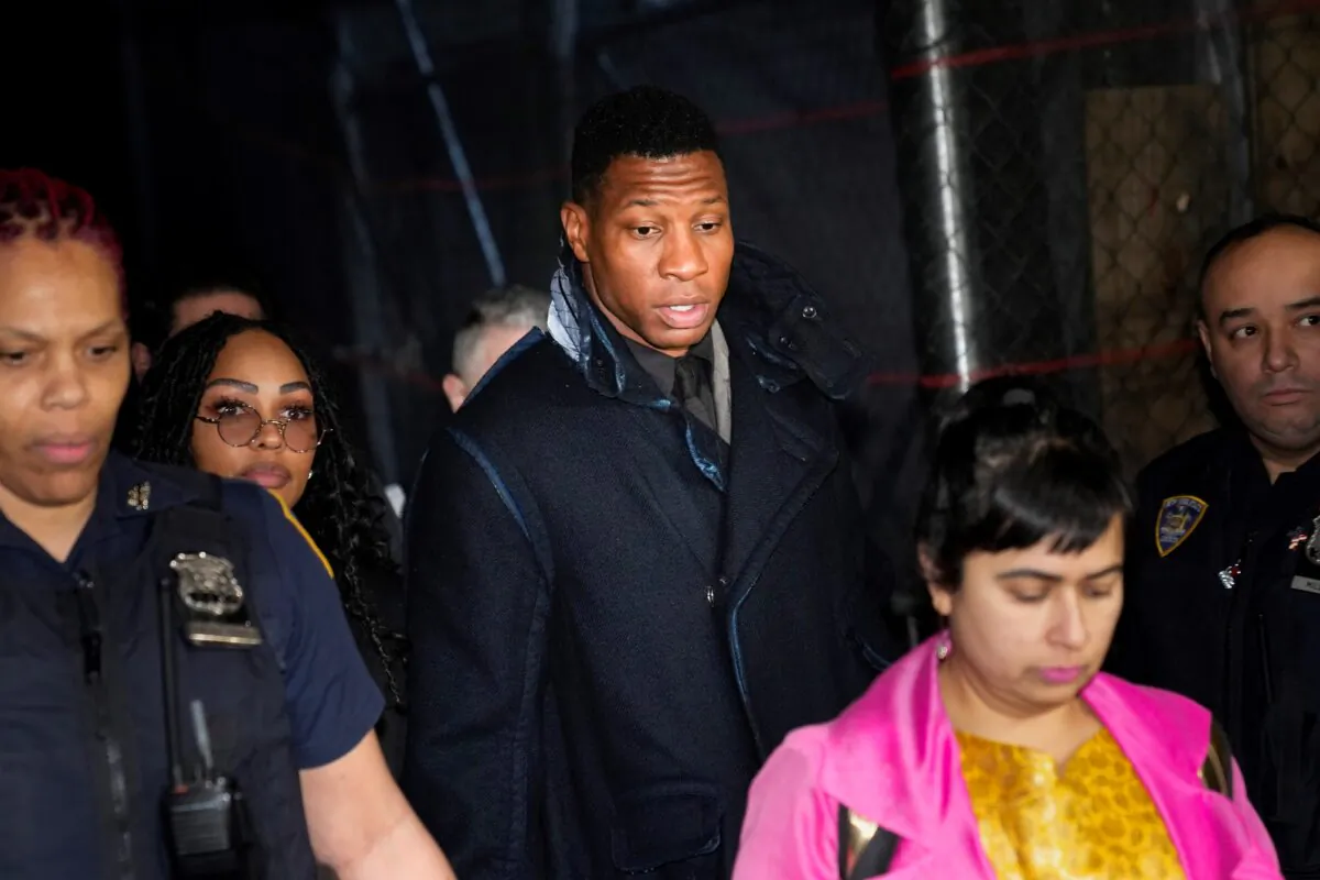 Jonathan Majors, third from left, leaves a courtroom in New York on Dec. 18, 2023. (Seth Wenig/AP Photo)