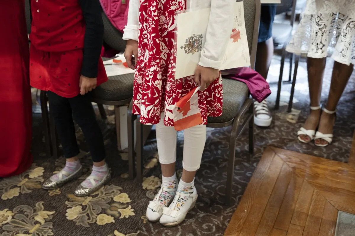Children stand to sing O Canada after being sworn-in as Canadian citizens at the Halifax Citadel in Halifax on May 24, 2023. (The Canadian Press/Darren Calabrese)