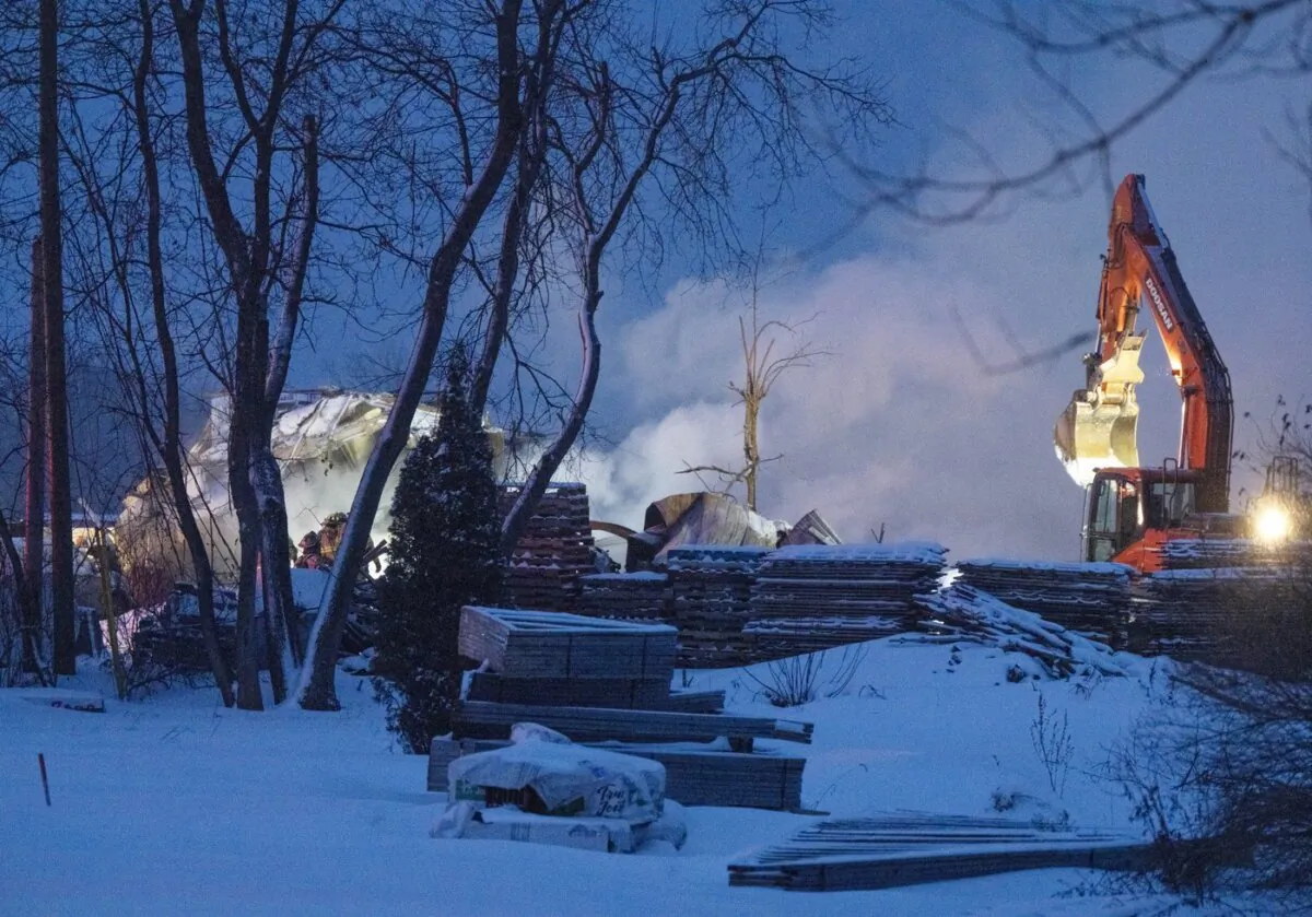 Firefighters work the scene after an explosion at a propane company, in St-Roch-de-L’Achigan, Que., on Jan. 12, 2023. (The Canadian Press/ Ryan Remiorz)