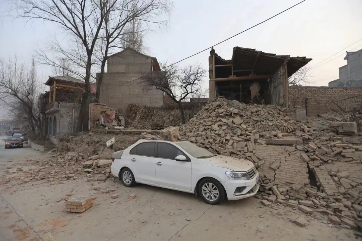 A vehicle is partially covered by a collapsed building in the aftermath of an earthquake in Dahejia village of Jishishan county in northwestern China's Gansu province on Dec. 19, 2023. (Chinatopix via AP)