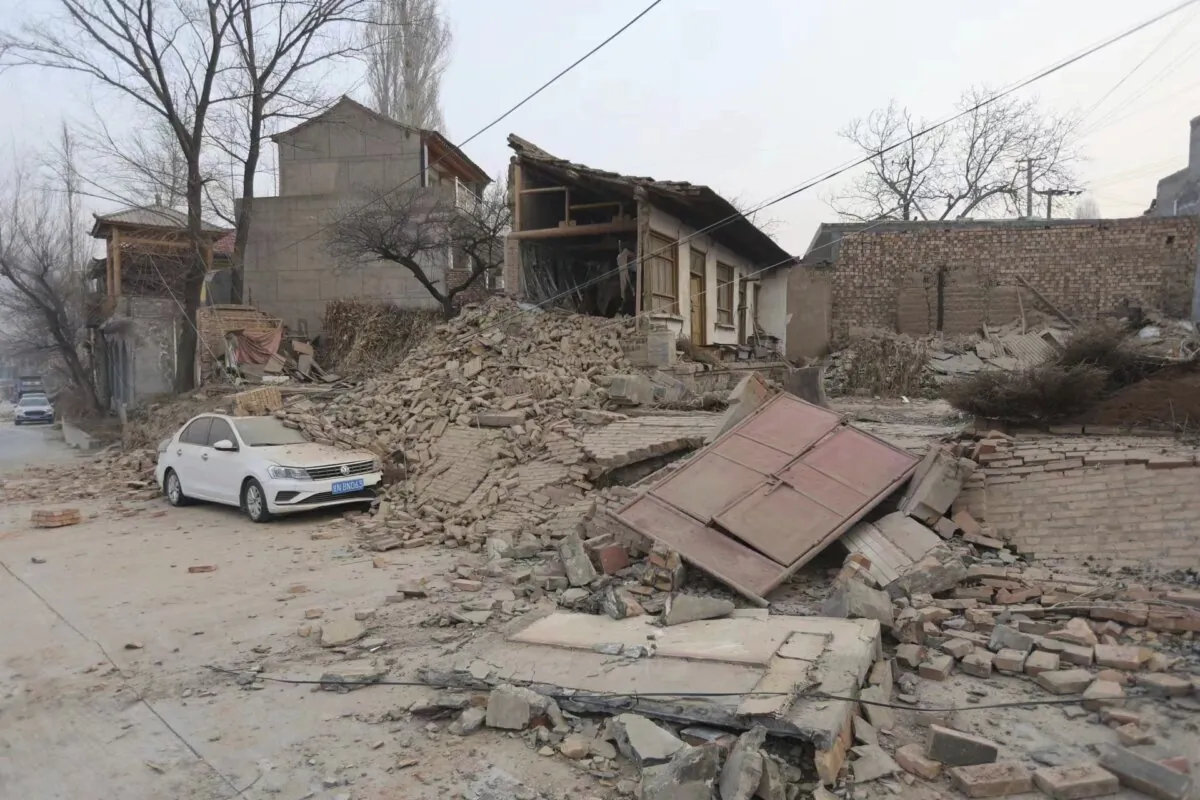 A vehicle is partially covered by a collapsed building in the aftermath of an earthquake in Dahejia village of Jishishan county in northwestern China's Gansu province on Dec. 19, 2023. (Chinatopix via AP)