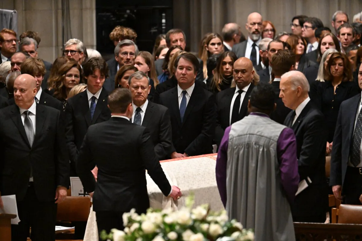 President Joe Biden (R) looks on as the casket is removed during a memorial service for former Supreme Court Justice Sandra Day O'Connor at the National Cathedral in Washington on Dec. 19, 2023. (Jim Watson/AFP via Getty Images)