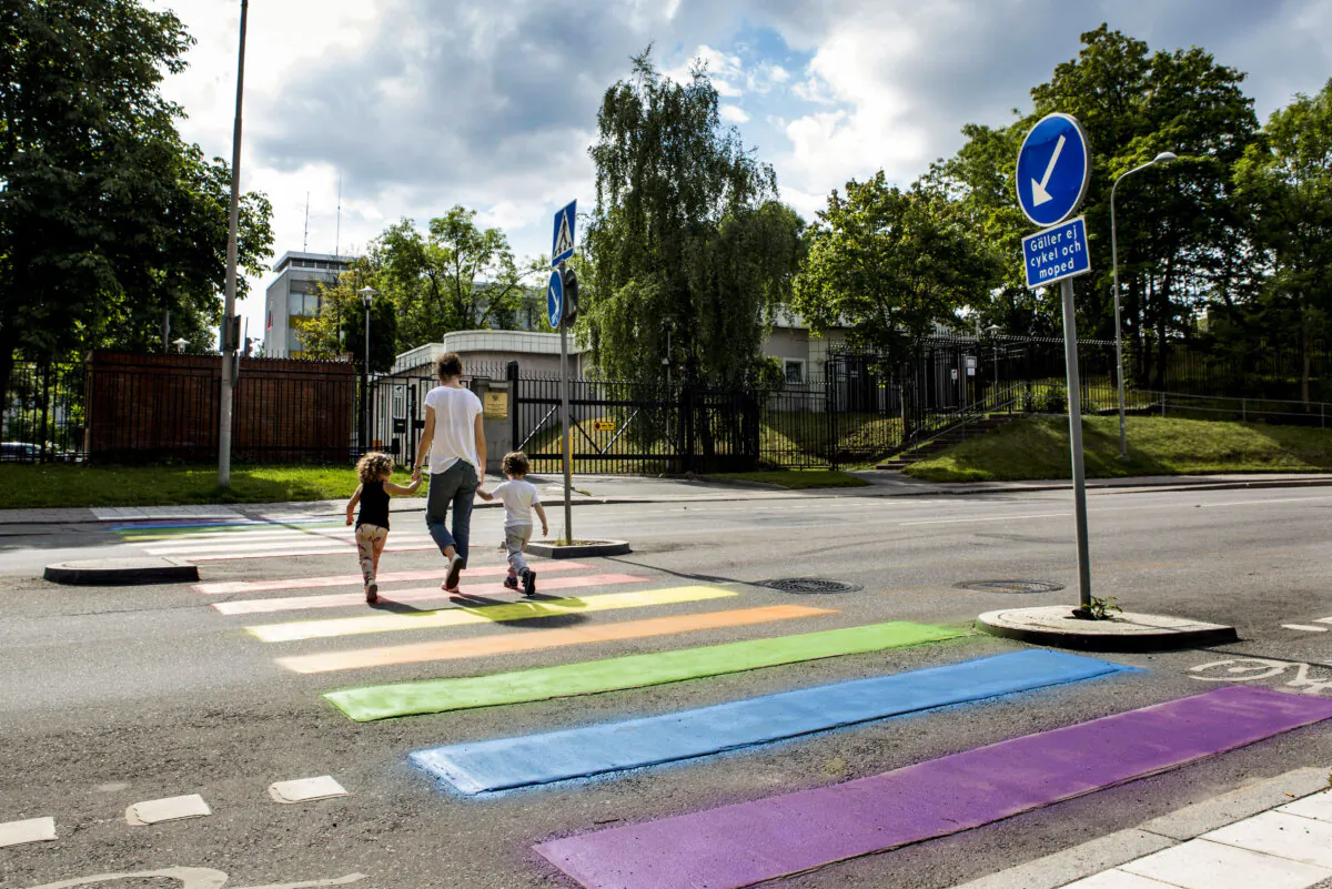 A mother and her children walk across a zebra crossing in Stockholm on Aug. 11, 2013. (CHRISTINE OLSSON/AFP via Getty Images)