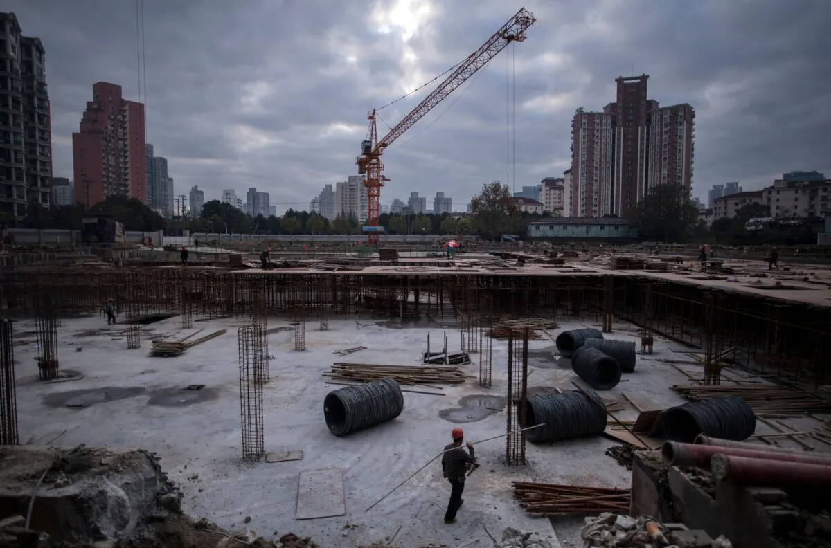 A man works at a construction site of a residential skyscraper in Shanghai, China, on Nov. 29, 2016. (Johannes Eisele/AFP via Getty Images)