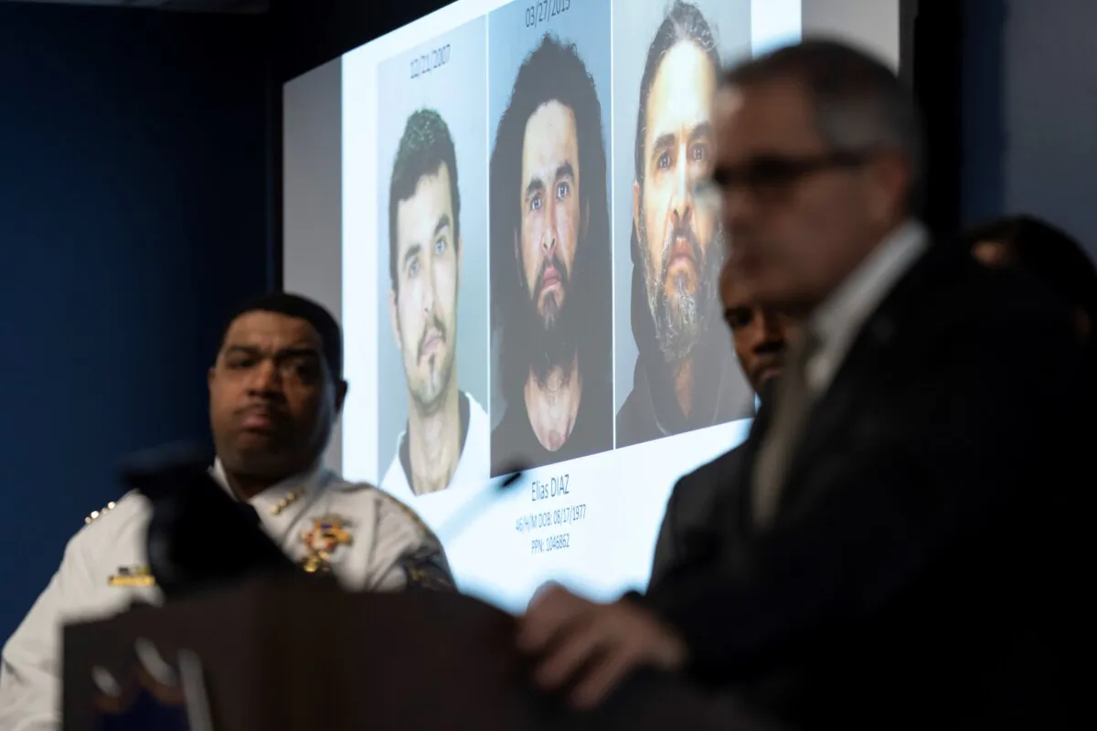 Images of suspect Elias Diaz are projected on a screen between Interim Police Commissioner John Stanford, Jr. (L), and District Attorney Larry (R) during a news conference in Philadelphia on Dec. 19, 2023. (Matt Rourke/AP Photo)
