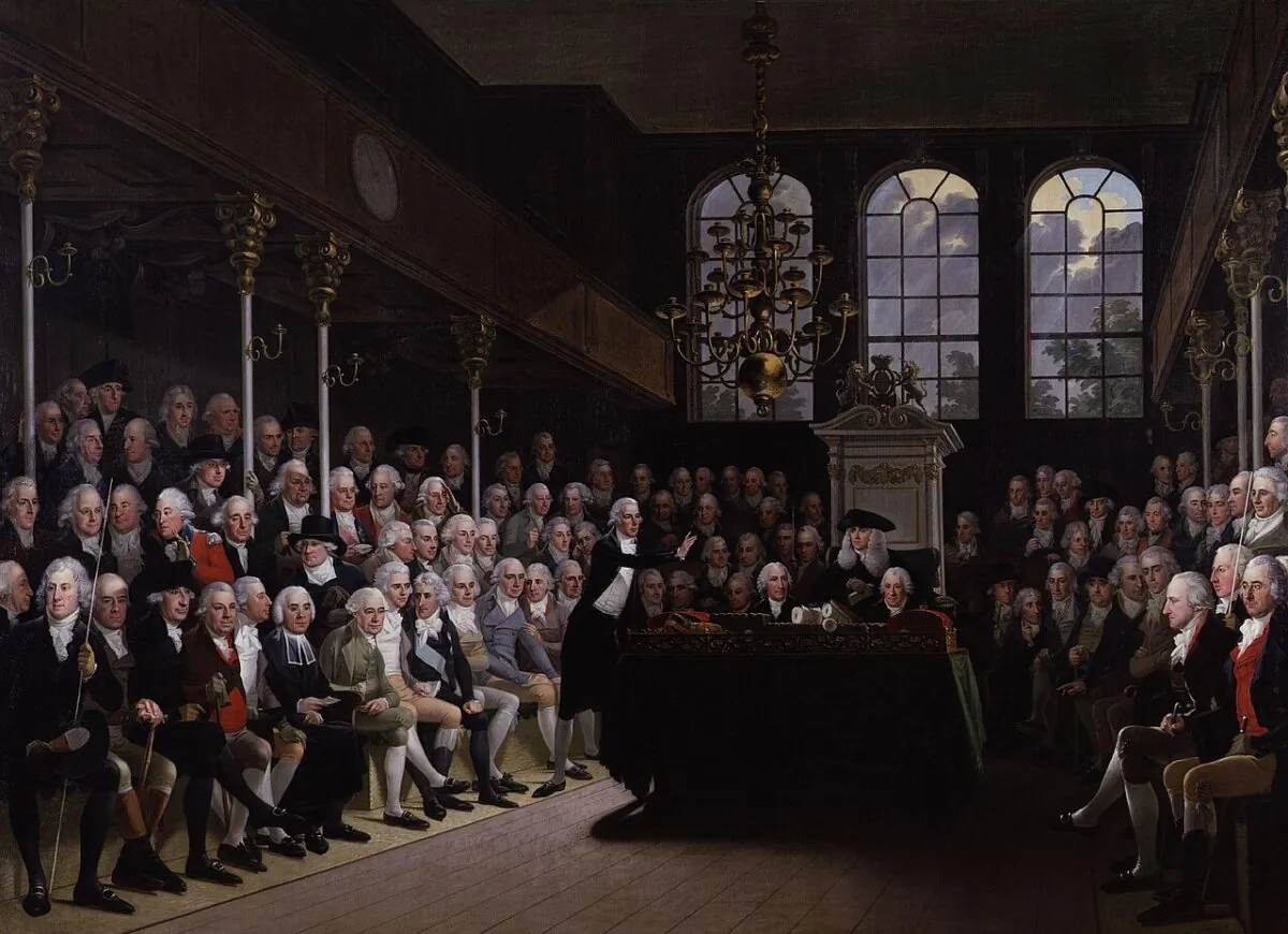 Prime Minister William Pitt (standing center) addressing the Commons on the outbreak of the war with France (1793), 1798, by Anton Hickel. (Public Domain)