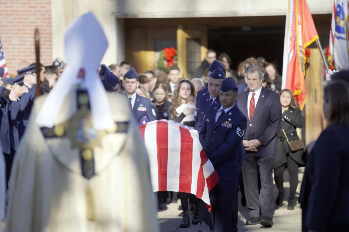 Mourners exit St. Agnes Church in Dalton, Mass., on Dec. 20, 2023, after the funeral for Staff Sgt. Jake Galliher of the U.S. Air Force. (Ben Garver/The Berkshire Eagle via AP)