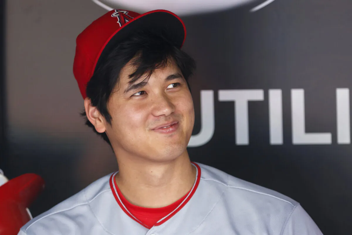 Los Angeles Angels designated hitter Shohei Ohtani looks on from the dugout ahead of a baseball game against the Toronto Blue Jays in Toronto on July 30, 2023. (Cole Burston/The Canadian Press via AP)