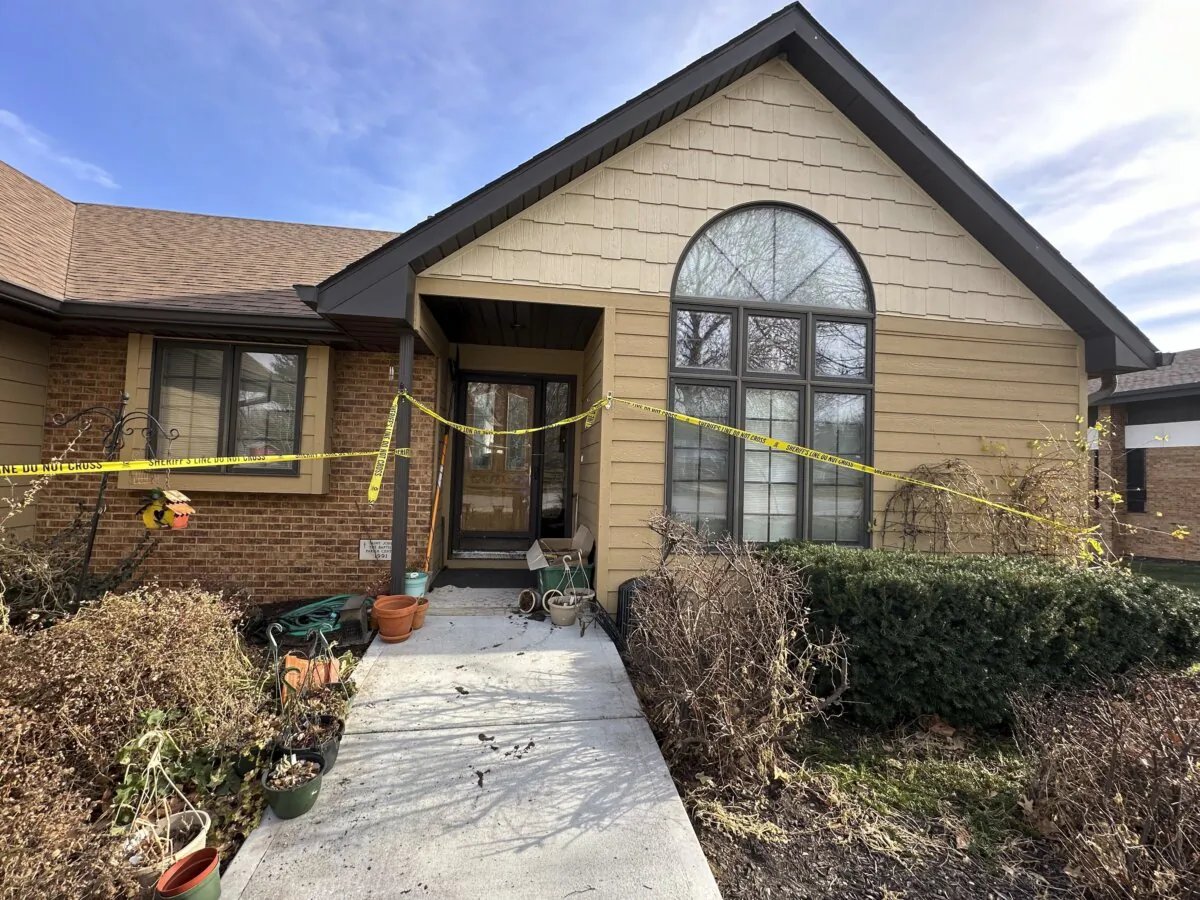 The front door of the rectory where the Rev. Stephen Gutgsell's was fatally stabbed in tiny Fort Calhoun, Neb., on Dec. 10, 2023, remained wrapped in crime scene tape on Dec. 14, 2023. (Josh Funk/AP Photo)