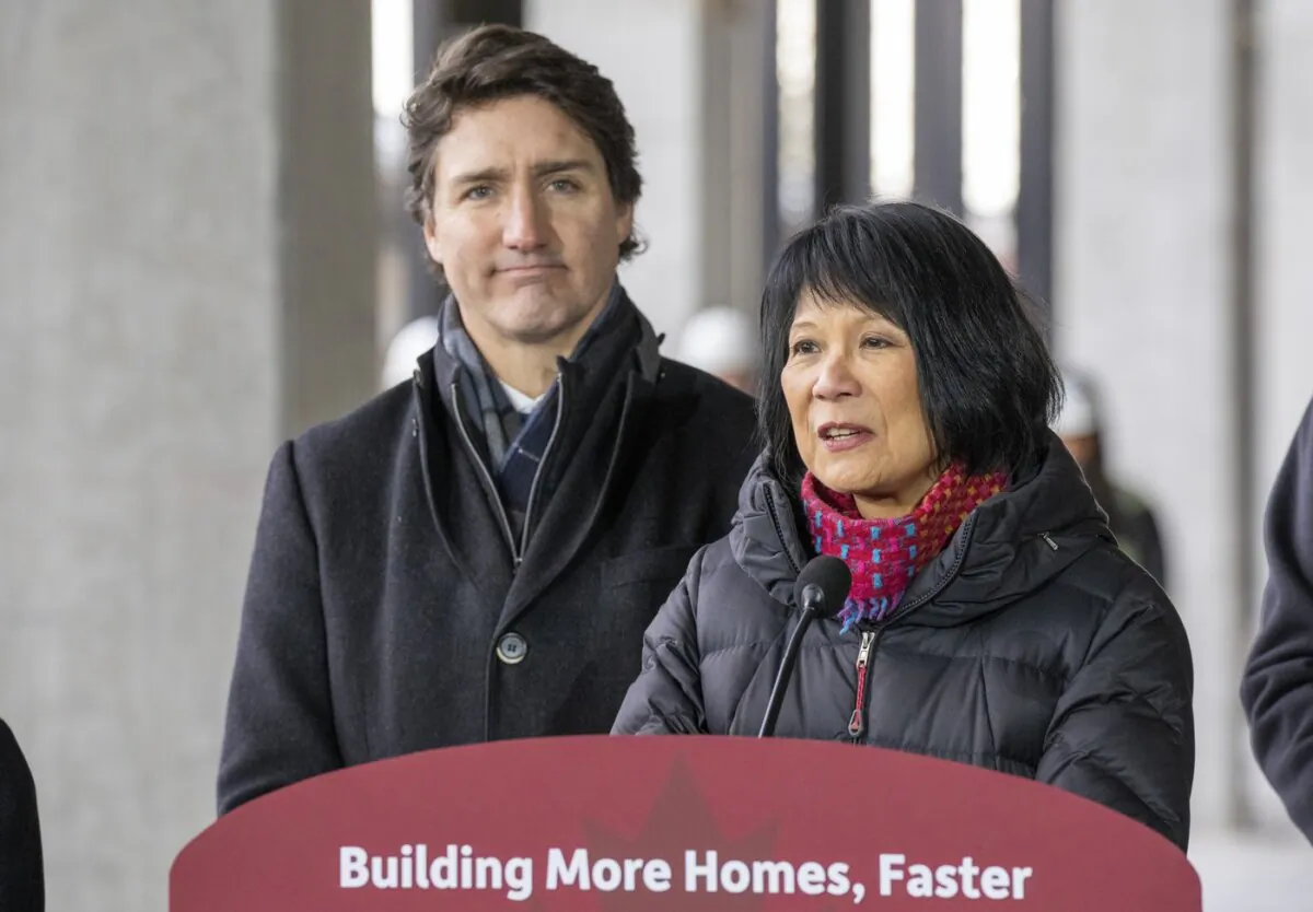 Prime Minister Justin Trudeau (L) listens as Toronto Mayor Olivia Chow speaks at a housing announcement in Toronto, on Dec. 21, 2023. (The Canadian Press/Frank Gunn)