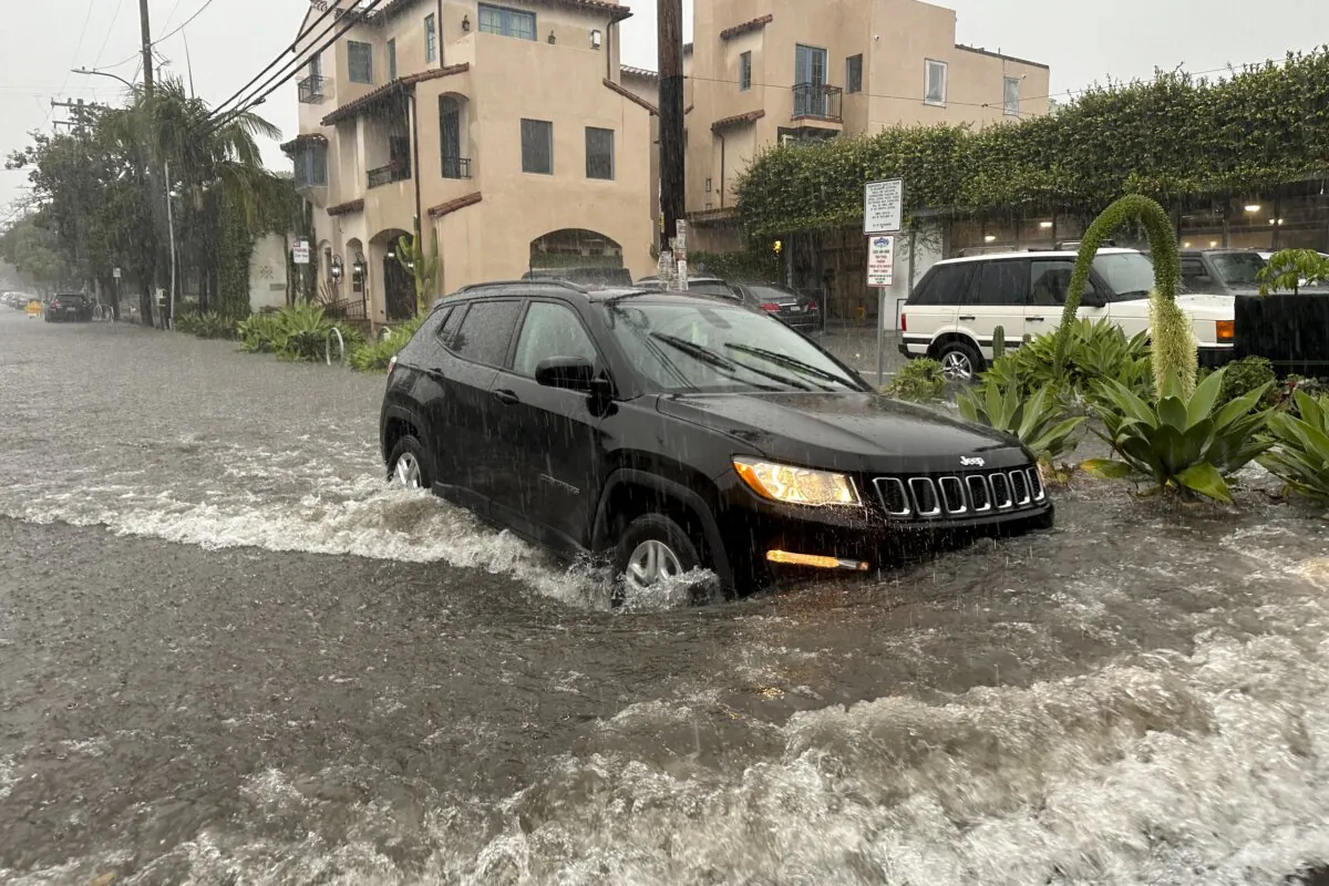 A motorist makes their way through a flooded street as rain comes down in Santa Barbara, Calif., on Dec. 21, 2023. (Eugene Garcia/AP Photo)