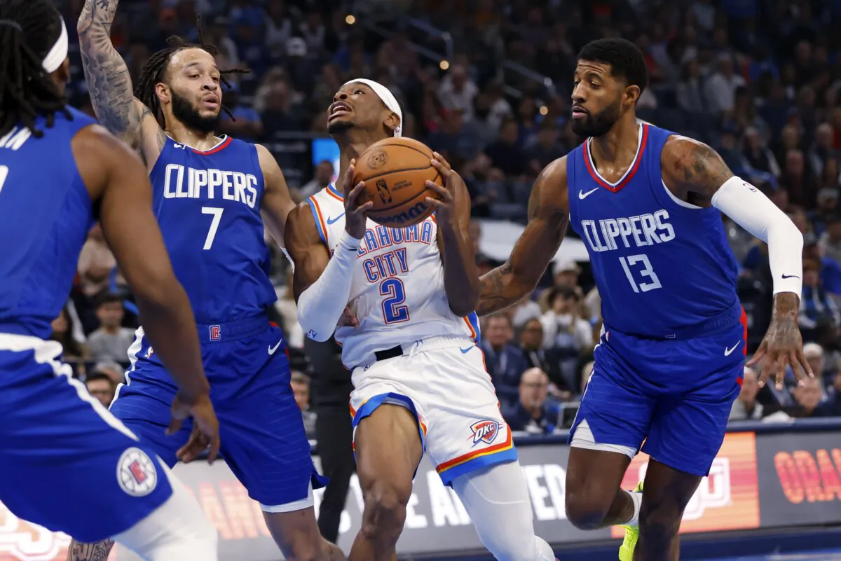 Oklahoma City Thunder guard Shai Gilgeous-Alexander (2) drives to the basket between Los Angeles Clippers guard Amir Coffey (7) and forward Paul George (13) during the first half of an NBA basketball game in Oklahoma City on Dec. 21, 2023. (Nate Billings/AP Photo)