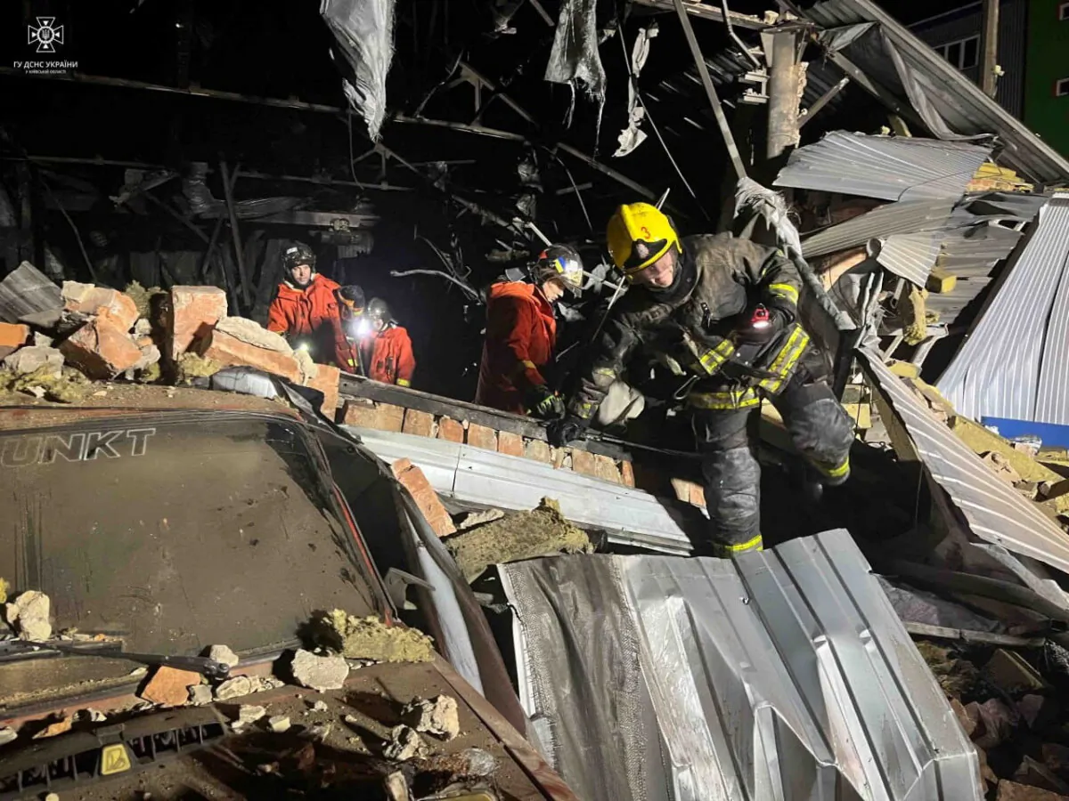 Firefighters work at a site of a warehouse heavily damaged during a Russian drone strike, in Kyiv region, Ukraine, released on Dec. 21, 2023. (Press service of the State Emergency Service of Ukraine in Kyiv region/Handout via Reuters)