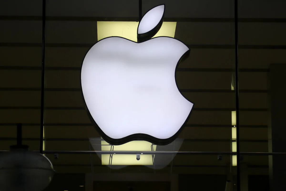 The Apple logo is illuminated at a store in the city center of Munich on Dec. 16, 2020. (Matthias Schrader/AP Photo)