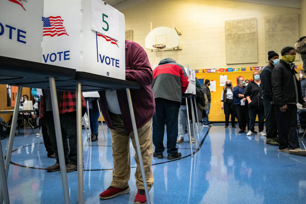 Voters fill out their ballots at a school gymnasium in Lansing, Mich., on November 3, 2020. (John Moore/Getty Images)