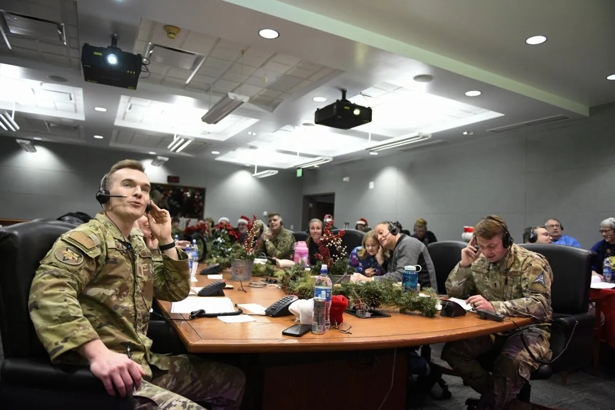 Volunteers answering phones and emails from children around the globe during the annual NORAD Tracks Santa event on Peterson Air Force Base in Colorado Springs, Colo., on Dec. 24, 2022. (Chuck Marsh/Department of Defense via AP)