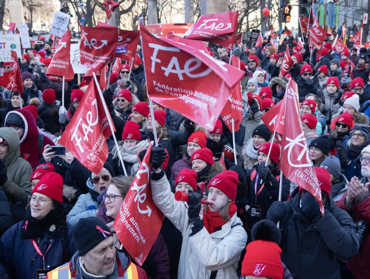 Striking teachers and their supporters hold a rally in front of Premier François Legault's office, in Montreal on Dec. 22, 2023. (The Canadian Press/Ryan Remiorz)