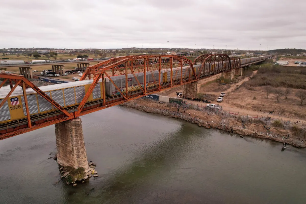 A freight train crosses the border between Mexico and the United States after a five-day suspension due to U.S. authorities closing railway bridges in Eagle Pass and El Paso, Texas, in order to redirect personnel to stop an increase in illegal immigration, as seen from Piedras Negras, Cohauila, Mexico, on Dec. 22, 2023. (Jose Luis Gonzalez/Reuters)