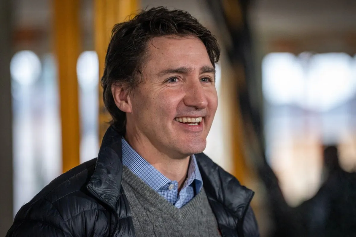 Trudeau smiles at the media before a news conference for a housing announcement in Vancouver, B.C., Dec. 15, 2023. (The Canadian Press/Ethan Cairns)