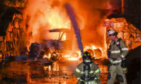 Truck Carrying Gas Hits Railroad Bridge and Explodes as Train Passes Overhead