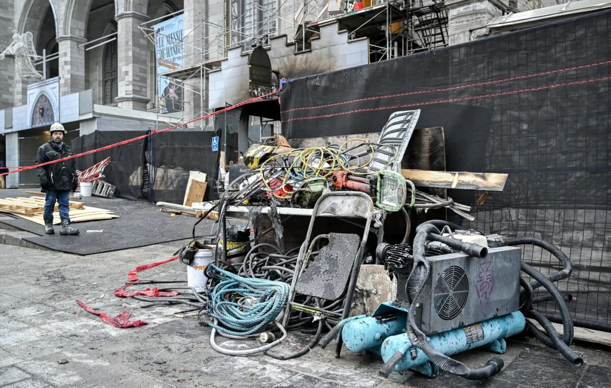 Charred construction equipment is shown at the Notre Dame Basilica in Montreal after a fire at the historic site, on Dec. 24, 2023. (The Canadian Press/Graham Hughes)