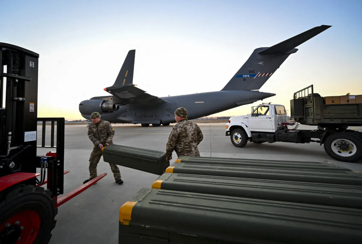 Ukrainian military forces move U.S.-made military equipment, and other military assistance shipped from Lithuania, to Boryspil Airport in Kyiv, Ukraine, on Feb. 13, 2022. (Sergei Supinsky/AFP via Getty Images)